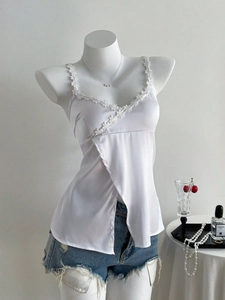 Detail of white silk camisole with delicate lace trim and elegant V-neck design