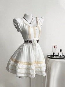 White vintage dress with lace trim, rose embroidery and puff sleeves on mannequin