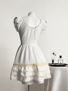 White vintage lace puff sleeve dress with floral embroidery and tiered skirt back view