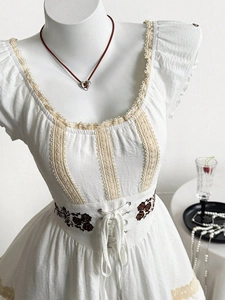 White vintage dress with hollow lace stitching, puff sleeves and rose embroidery details