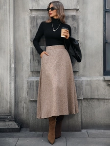 Outdoor street photography of a brown high-waisted wool A-line skirt in elegant urban style