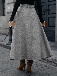 Close-up of gray wool A-line skirt featuring fine texture and elastic waistband details
