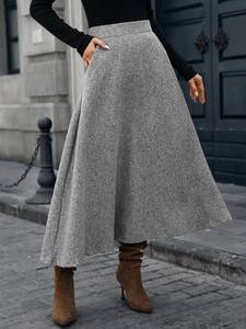 Detailed texture of grey wool blend A-line skirt with heavy drape for autumn