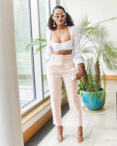 Women's chic two-piece set featuring a white crop top and high-waisted pink belted trousers