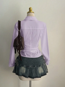 Back view of a lavender slim-fit shirt paired with a grey pleated denim skirt
