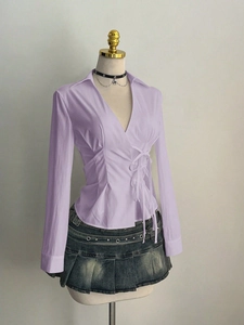 Detail of lavender long sleeve shirt showing waist tie design and pleated texture