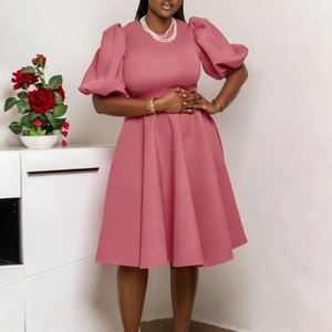 Detailed close-up of puffy short sleeves and cinched waist on a dusty pink A-line dress