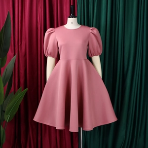 Close-up of elegant puff sleeves and crew neck on a mauve pink A-line dress