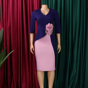 Detail of elegant pleated sleeves and large 3D fabric flower on this stylish African dress