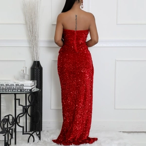 Close-up of the back view of a sparkling red sequin evening gown with a hidden zipper