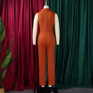 Back view of a sleeveless orange jumpsuit with a lapel collar and belted waistline