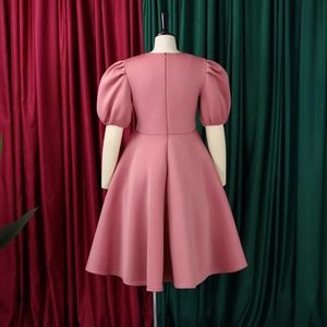 Detail of the pink puff sleeve dress featuring elastic cuffs and smooth fabric texture