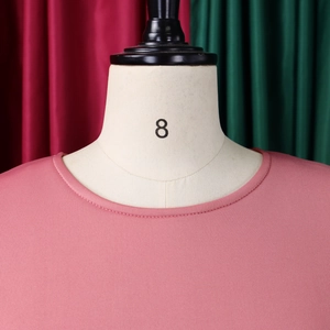 Close-up of elegant round crew neck design on a dusty rose puff sleeve fashion dress