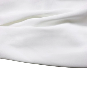 Macro shot of high-density white knit fabric texture with smooth surface for summer dress
