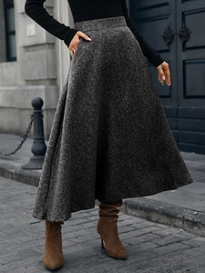 Macro detail of high-waist grey wool A-line skirt with elegant drape texture