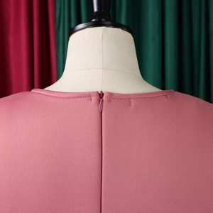 Detailed close-up of pink puff sleeve dress featuring a neat invisible back zipper