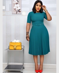 Detail of elegant dark teal pleated dress with waist belt and short sleeves in studio