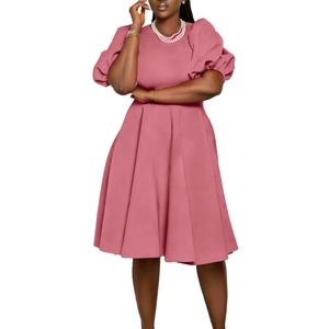 Detail of elegant light pink dress with puff sleeves and refined A-line skirt texture