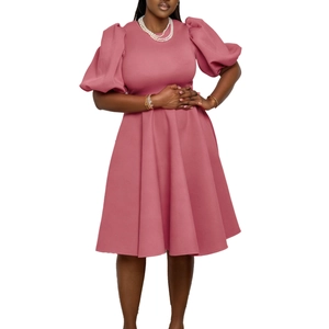 Close-up of elegant dusty rose dress featuring stylish puffed sleeves and round neckline