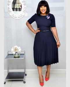 Detail of dark blue short sleeve pleated dress with waist belt and flower brooch decoration