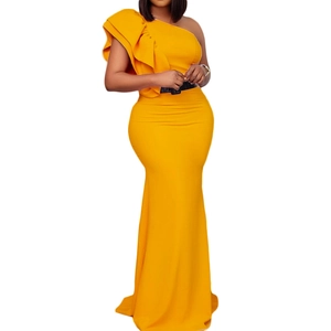Detail of bright yellow one-shoulder evening gown with layered ruffles and black belt