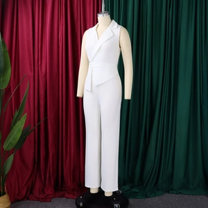 Detail of white sleeveless jumpsuit featuring notched lapels and self-tie waist belt