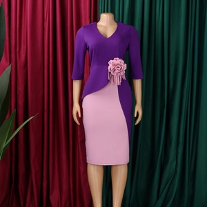 Detail of pink and purple patchwork dress featuring 3D floral applique and fringe trim