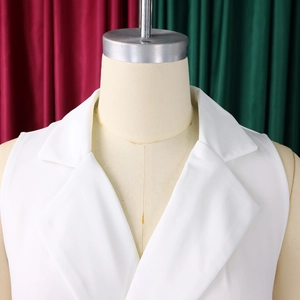 Detail of white sleeveless notch lapel jumpsuit showing classic V-neckline and woven texture
