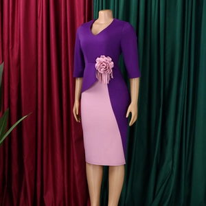 Detail of V-neck purple and pink dress featuring 3D floral accent and elegant fringe decor
