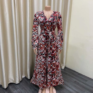 Detail of V-neck long sleeve jumpsuit featuring vibrant African print and wide leg cut