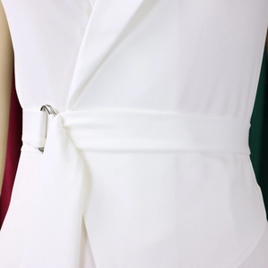 Detail of waist belt with silver double ring metal buckle on a white sleeveless jumpsuit