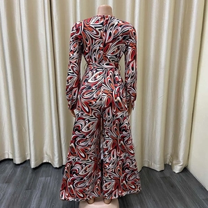 Detailed back view of wide-leg jumpsuit featuring vintage red and orange paisley print