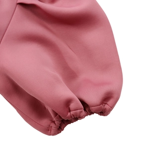 Detail of elegant pink puff sleeve cuffs with elastic shirring and fine stitching