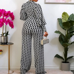 Chic houndstooth long sleeve wide leg jumpsuit for women with stylish silver handbag