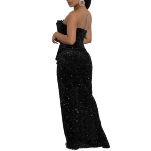 Detailed back view of a sequined black velvet off-shoulder evening gown with side ruffles