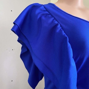 Close-up of layered ruffle sleeve detail on electric blue high waist evening dress