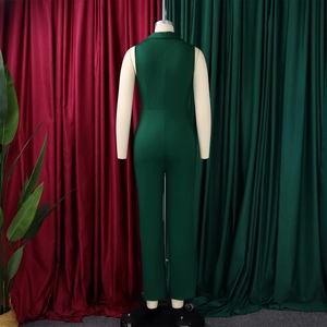 Back view of a sleeveless deep green jumpsuit with a sleek lapel collar and tied waist
