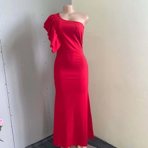Detailed view of the layered ruffles on the asymmetric shoulder of the red formal dress