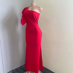 Detail of red one-shoulder dress showing ruffled sleeve and slim-fit waist silhouette
