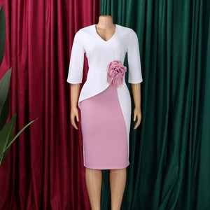 Detailed view of white V-neck bodice with 3D pink floral waist decoration and tassels