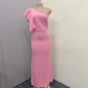 Detail of elegant pink one-shoulder dress featuring a large ruffle shoulder decoration