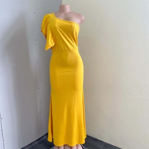 Detail of bright yellow one-shoulder maxi dress with dramatic ruffled pleats on the shoulder
