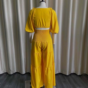 Detail of yellow two-piece summer set with lantern sleeves and smocked high waist pants