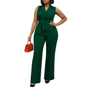 Detail of dark green sleeveless jumpsuit showing V-neck lapels and waist belt with metal buckle