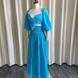 Detail of blue two-piece set featuring puff sleeves and tiered skirt texture