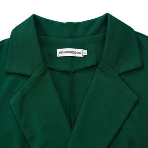 Detail of a dark green sleeveless jumpsuit showing the lapel collar and brand neck label