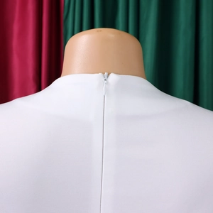 Detail of white dress back featuring a seamless concealed zipper and textured fabric