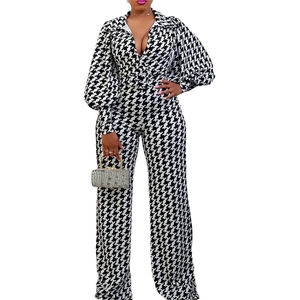 Elegant black and white houndstooth jumpsuit with deep V-neck, puff sleeves and wide legs