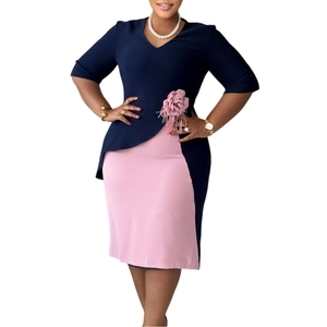 Detail of the pink 3D flower embellishment and pleated V-neckline on the navy blue dress