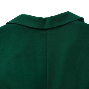 Detailed view of the dark green notched lapel and premium textured fabric on a jumpsuit
